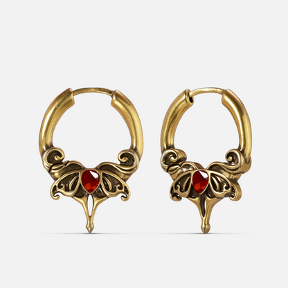 Gold-tone Crimson Wing hoop earrings with red teardrop stones and ornate pointed wing details