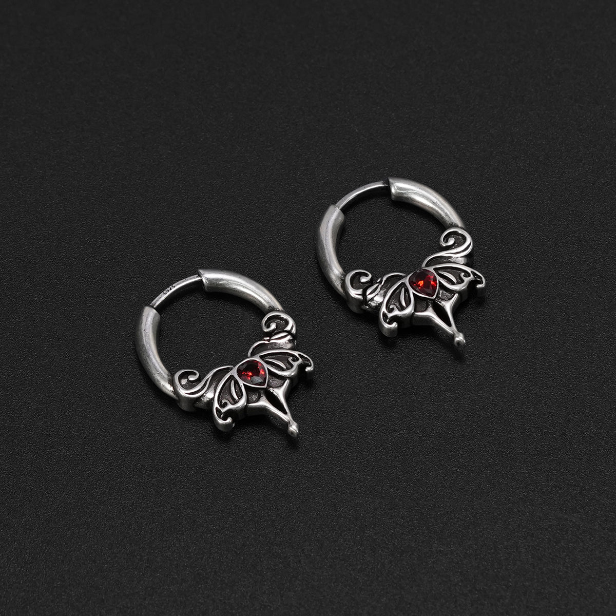 Pair of silver Crimson Wing hoop earrings with red center accents