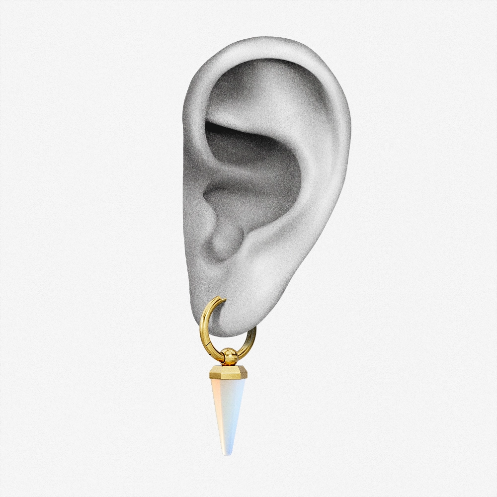 Gold-tone Crystal Prismatic hoop earring with an iridescent point positioned on an illustrated earlobe
