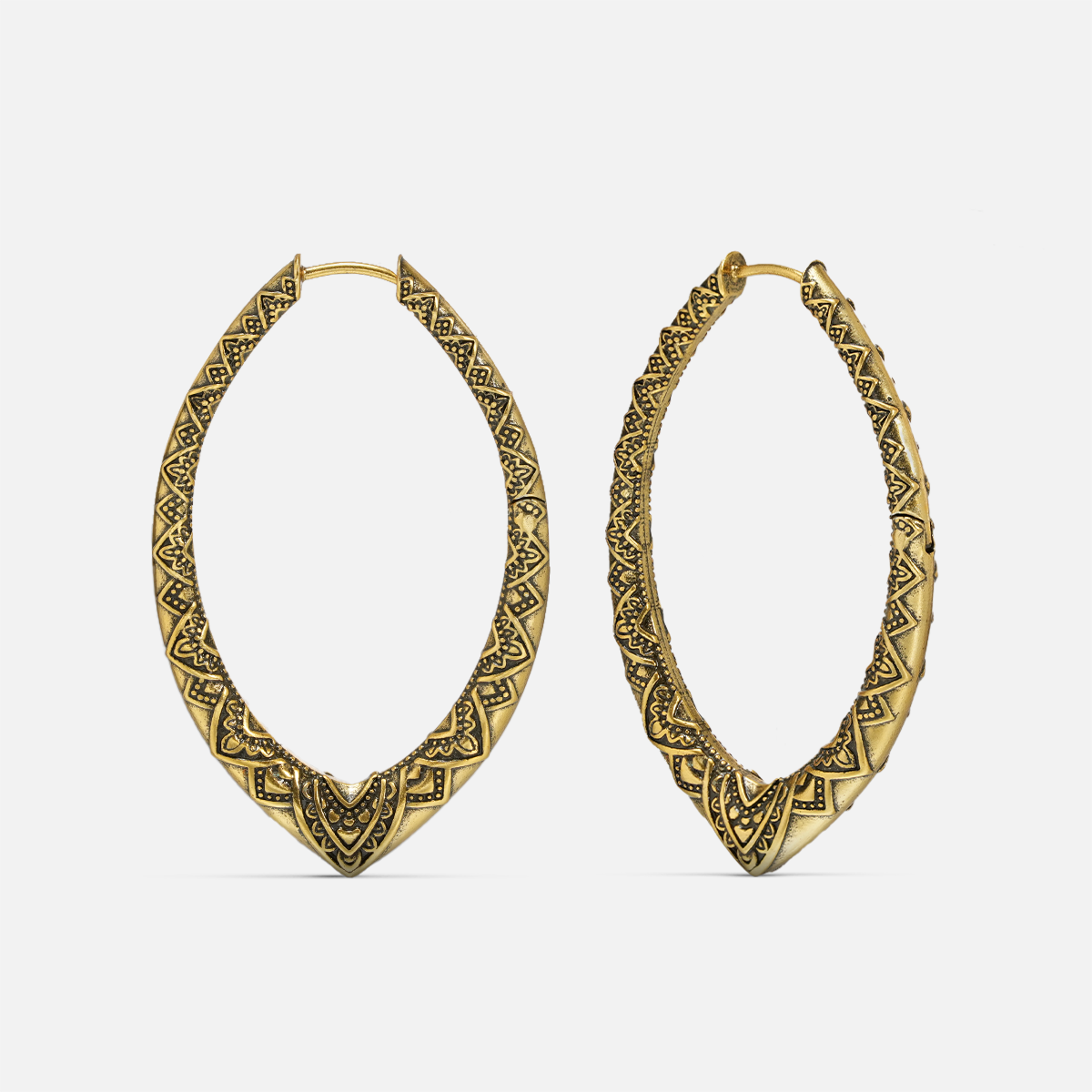 Pair of gold-tone marquise hoop earrings with engraved geometric and floral patterning