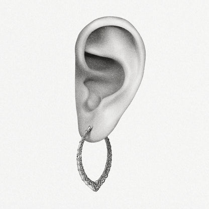 Silver Cultural Essence hoop earring shown on an ear illustration