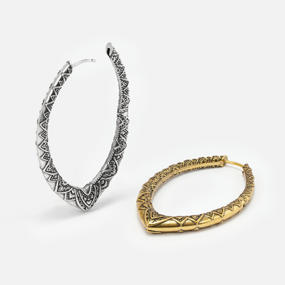 Silver and gold Cultural Essence hoop earrings shown open and lying flat