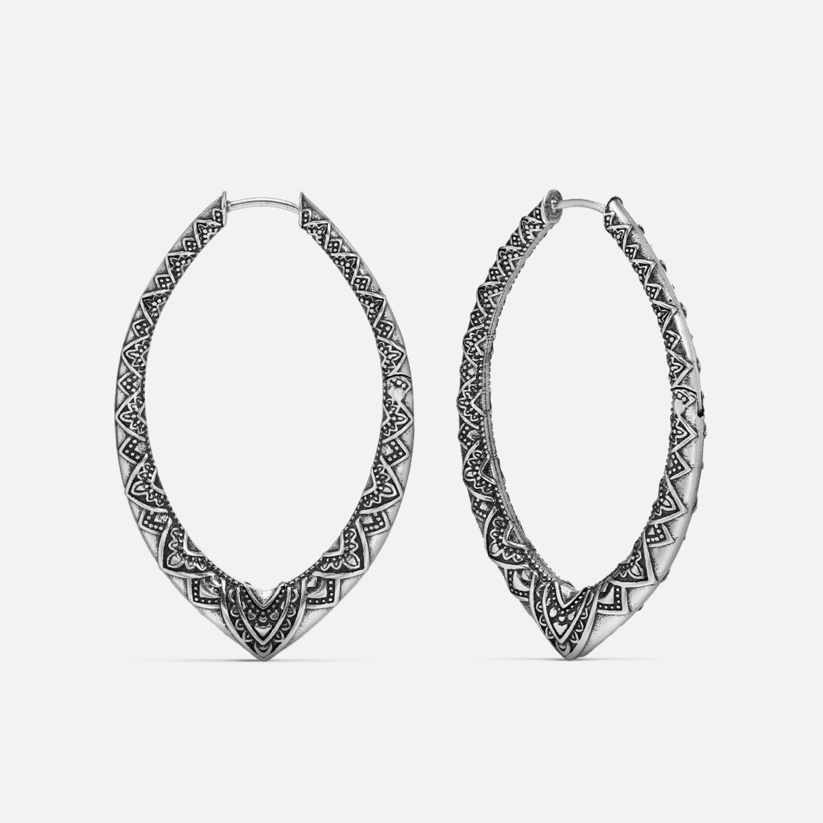 Pair of oxidized silver-tone marquise hoop earrings with engraved geometric and floral patterning