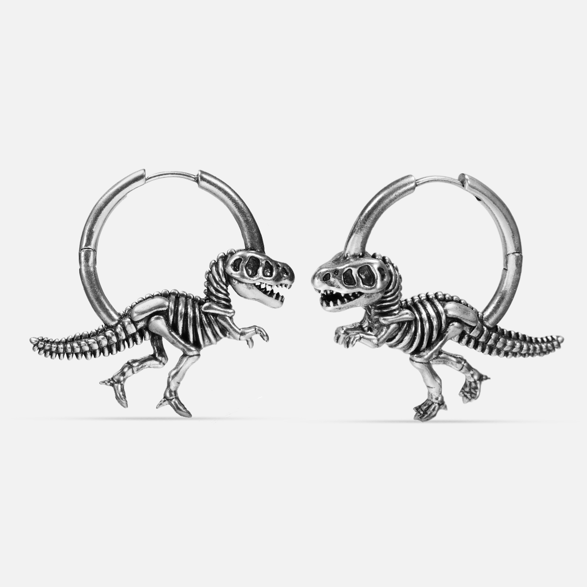 Silver-tone Dinosaur Delight hoop earrings with Tyrannosaurus skeleton pendants