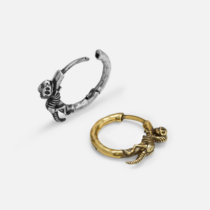 Silver and gold Dinosaur Legacy hoop earrings shown open and lying flat