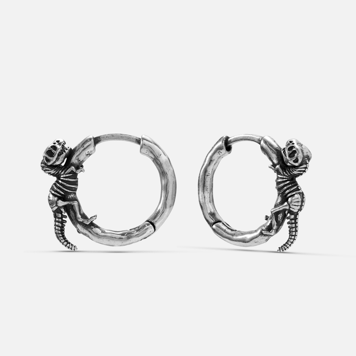 Silver-tone Dinosaur Legacy hoop earrings with small curled dinosaur fossil figures