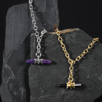 Silver and gold Dual Prism necklaces displayed on dark stone
