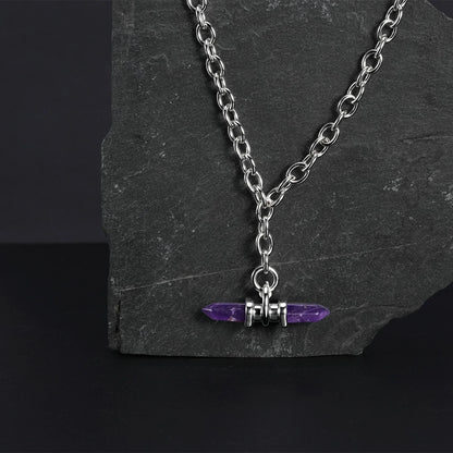 Silver Dual Prism necklace with purple pendant displayed on dark stone