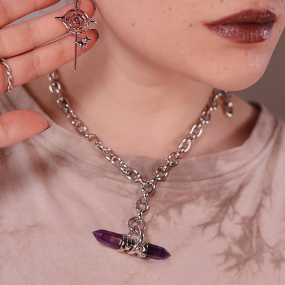 Model wearing the silver Dual Prism Necklace with a horizontal amethyst crystal pendant, chunky chain, and celestial gothic styling.