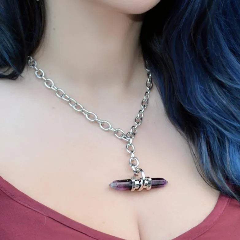 Model wearing the silver Dual Prism Necklace with a horizontal amethyst crystal pendant, chunky chain, and alternative gothic styling.