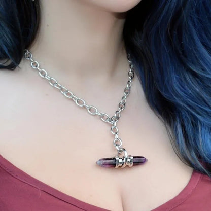 Model wearing the silver Dual Prism Necklace with a horizontal amethyst crystal pendant, chunky chain, and alternative gothic styling.
