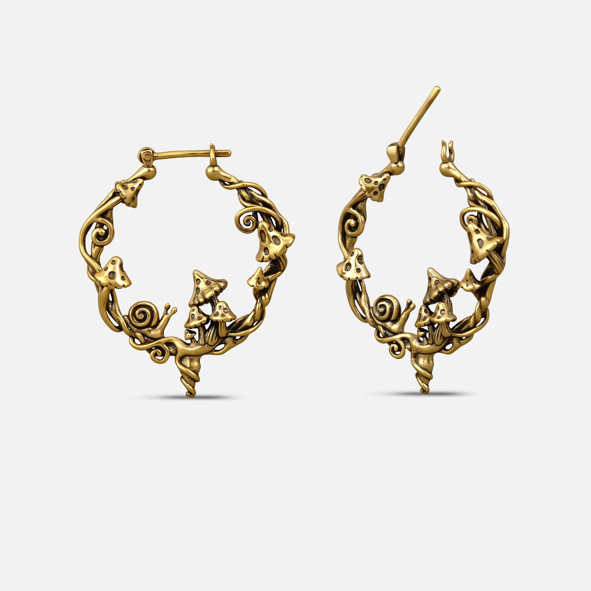 Pair of gold-tone hoop earrings featuring mushroom, snail, and swirling vine motifs, front and side view