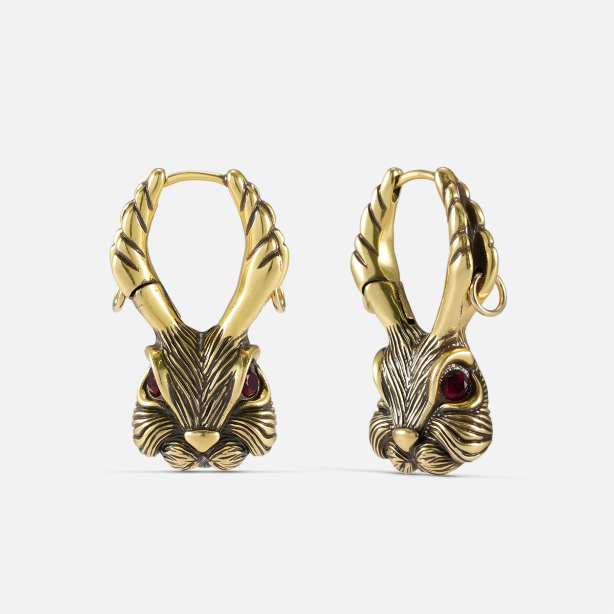 Pair of gold-tone jackalope hoop earrings featuring antler details and red gemstone eyes, front view