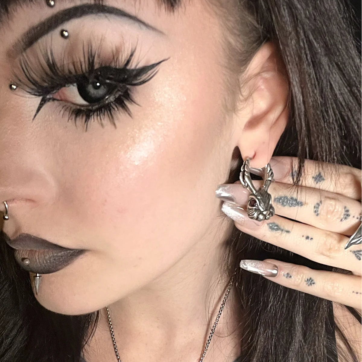 enchanted jackalope earrings shown in a model view, featuring silver jackalope-shaped drop earrings with sculptural antlers worn by the model