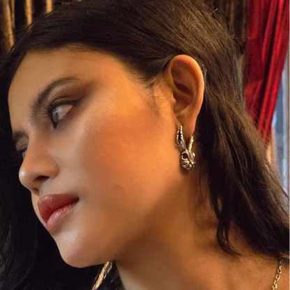 enchanted jackalope earrings worn by model in a side portrait, featuring silver rabbit-inspired earrings with horn details