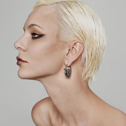 Model wearing a silver Enchanted Medusa hoop earring