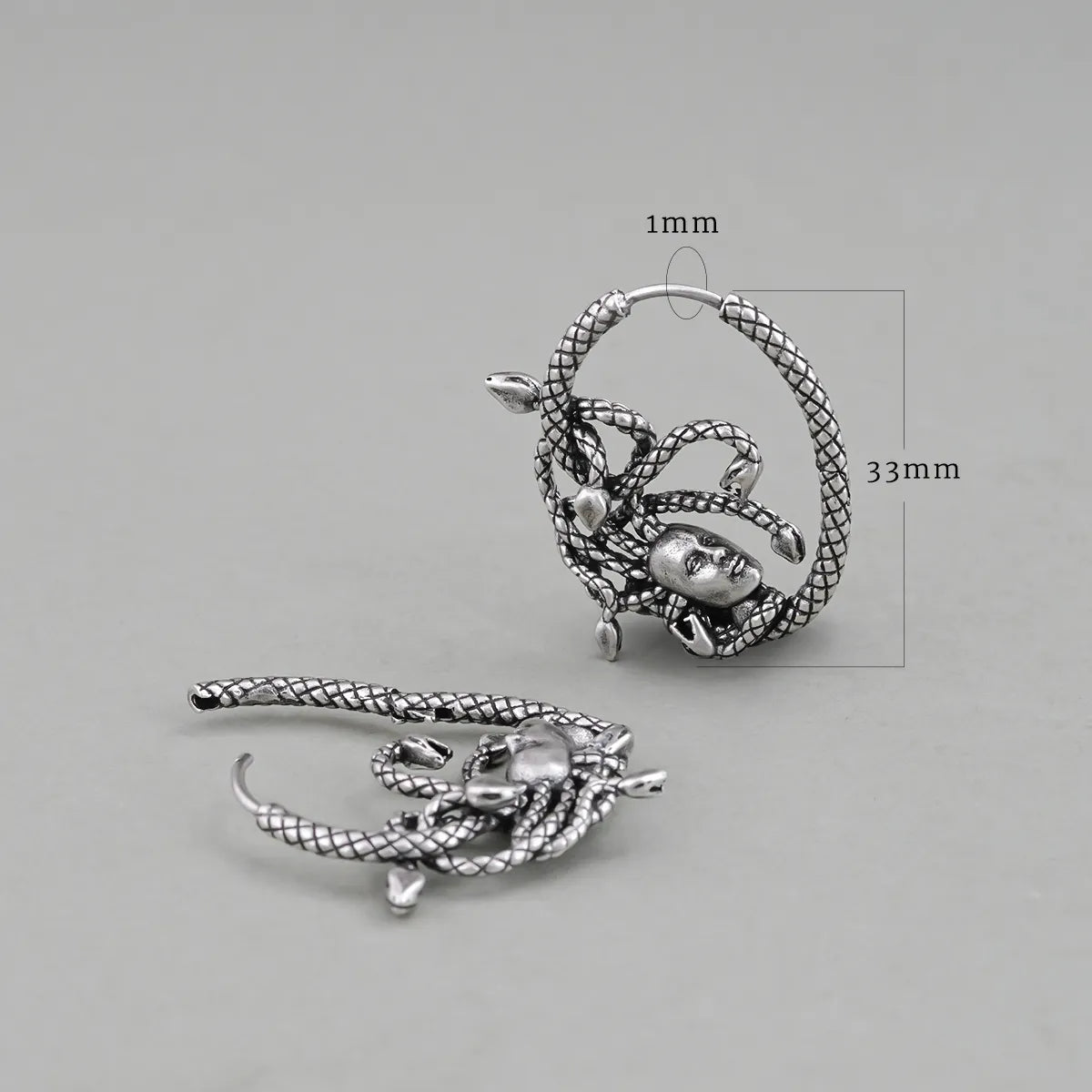 Silver Enchanted Medusa hoop earring shown upright and flat with dimensions