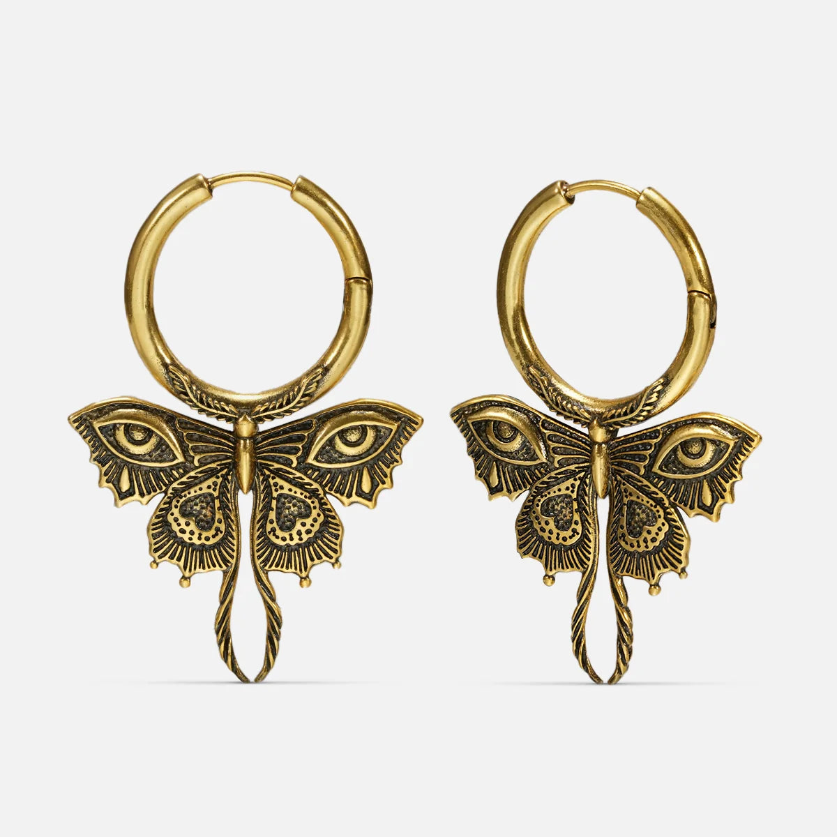 Pair of gold-tone Enchanted Moth hoop earrings with engraved wings, eye details, and long curled tails