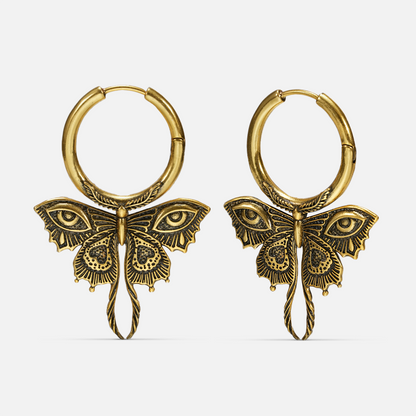 Pair of gold-tone Enchanted Moth hoop earrings with engraved wings, eye details, and long curled tails