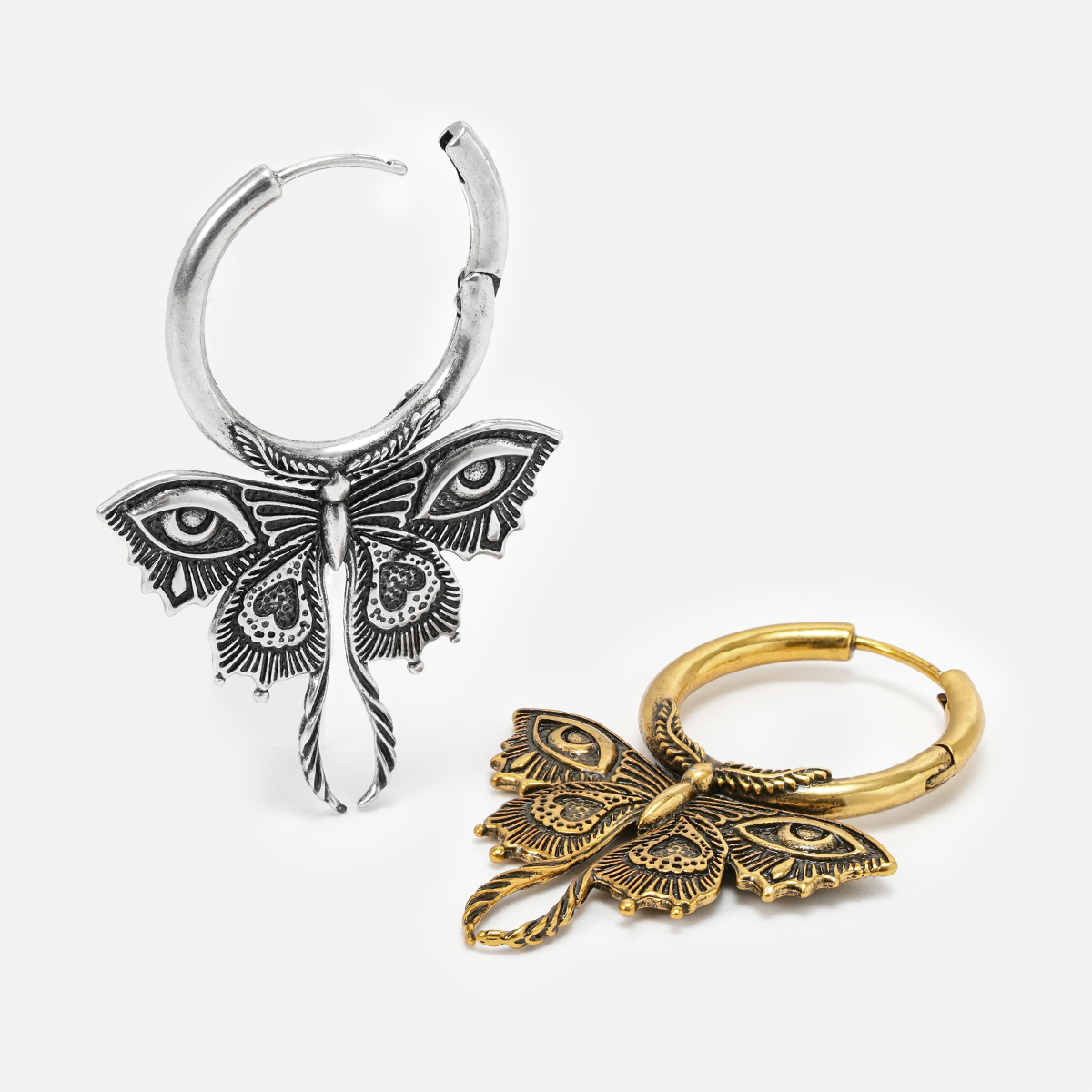 Silver and gold-tone Enchanted Moth hoop earrings shown upright and lying flat to reveal the hinged hoops