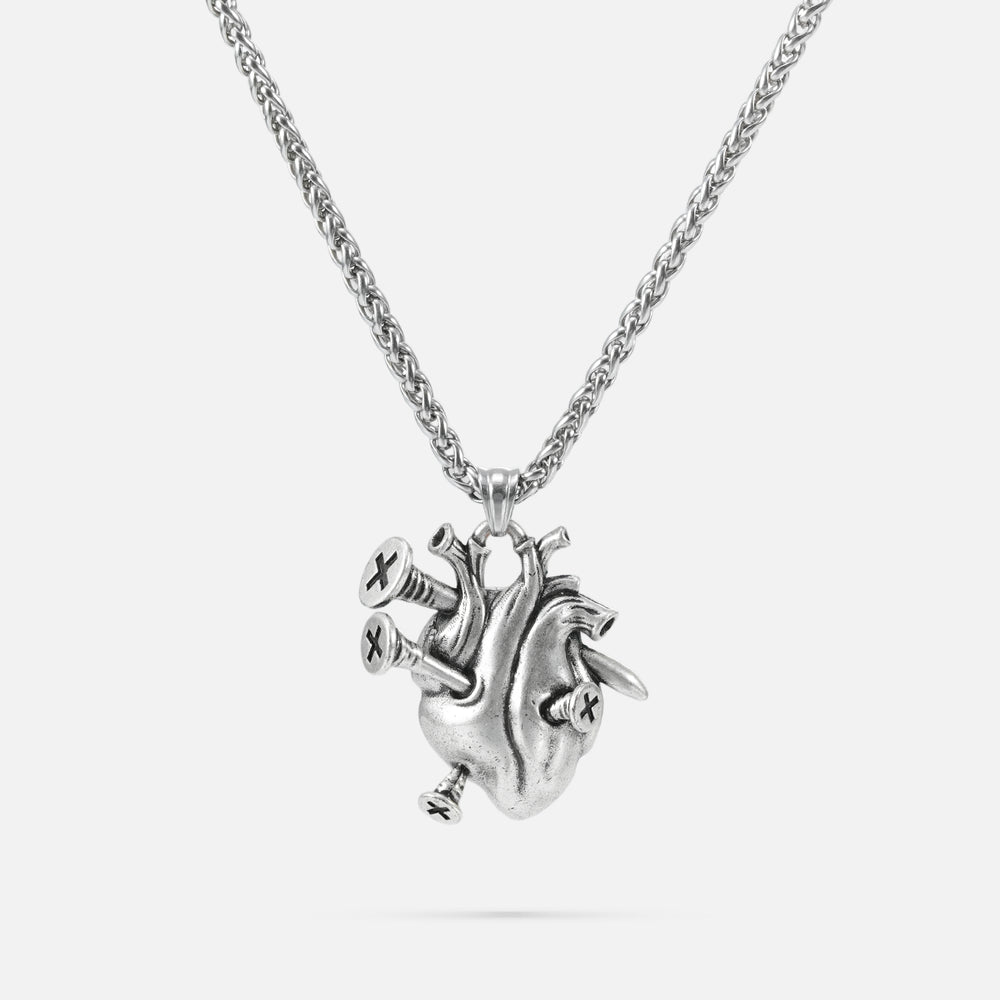 Silver-tone chain necklace with a sculpted anatomical heart pendant