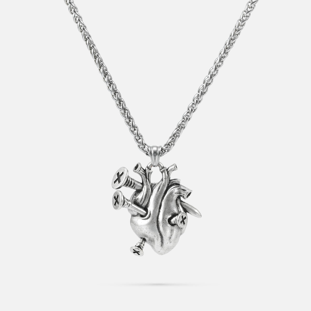 Silver-tone chain necklace with a sculpted anatomical heart pendant