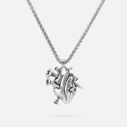 Silver-tone chain necklace with a sculpted anatomical heart pendant