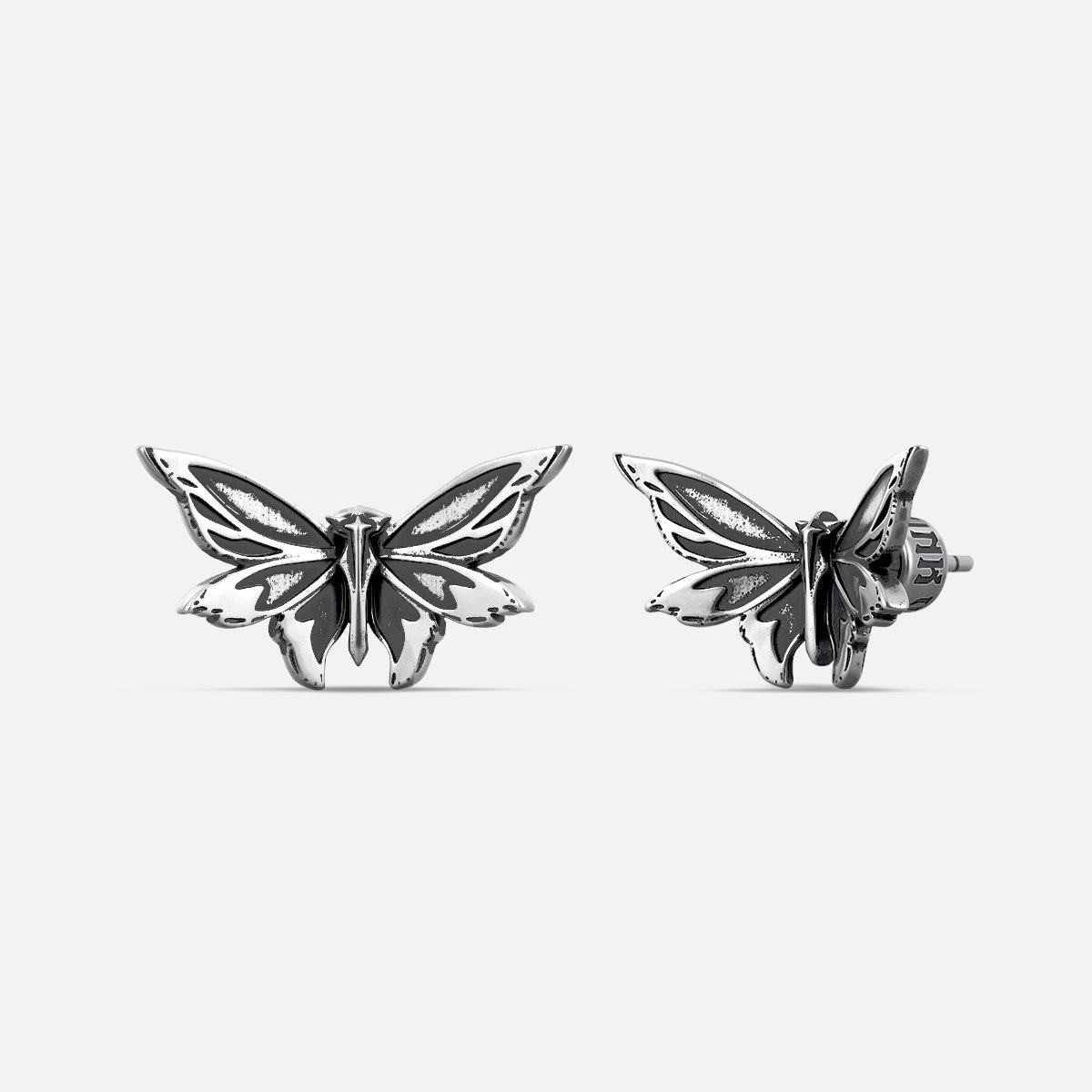 Pair of silver Eternal Moth ear studs shown from front and side
