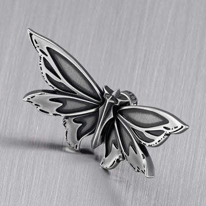 Close-up of silver Eternal Moth ear stud with layered wing details