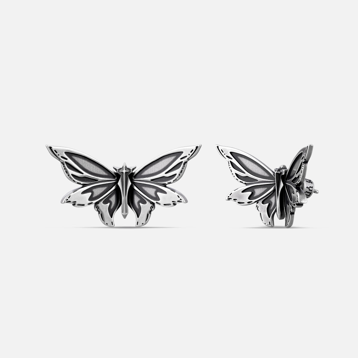 Pair of silver Eternal Moth ear studs shown from front and side angles