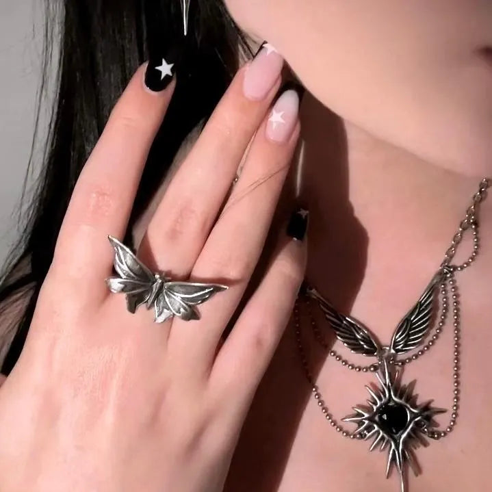 Model wearing silver Eternal Moth Ring with gothic moth wing design and matching moth jewelry styling