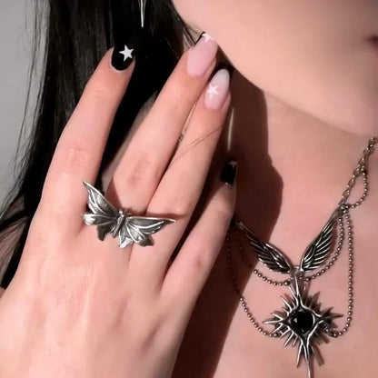 Model wearing silver Eternal Moth Ring with gothic moth wing design and matching moth jewelry styling