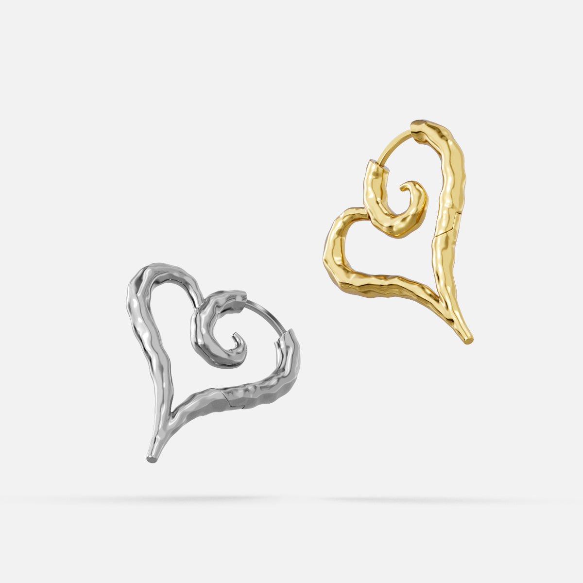 Silver and gold Ethereal Heartflow earrings with open heart silhouettes