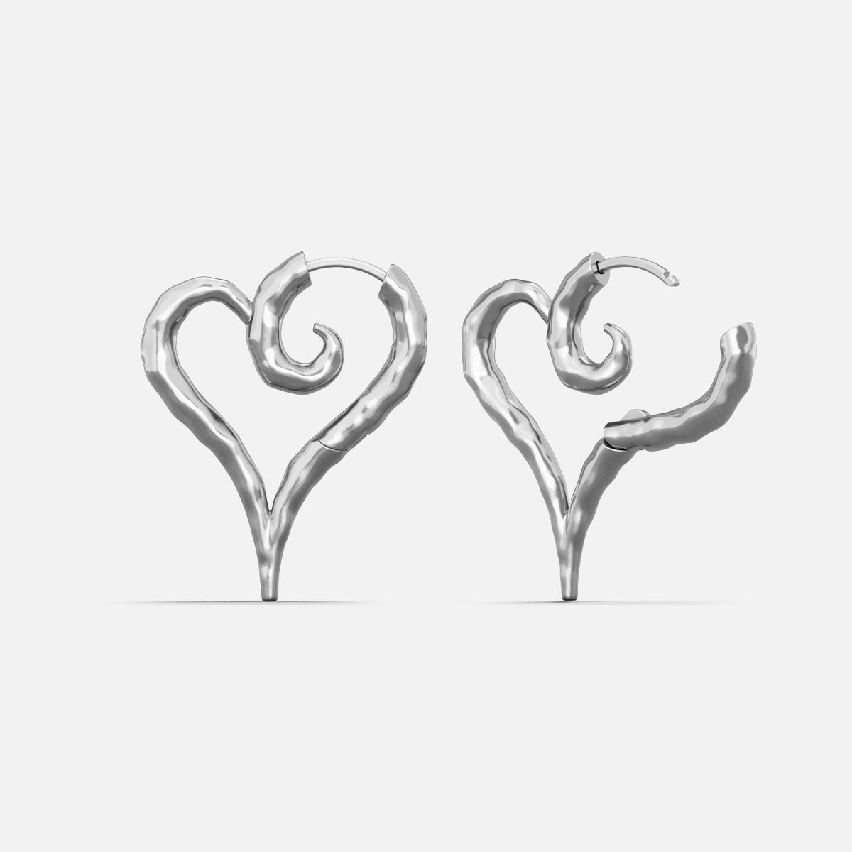 Silver-tone heart-shaped hoop earrings with a hammered texture and curled spiral detail, shown as a pair