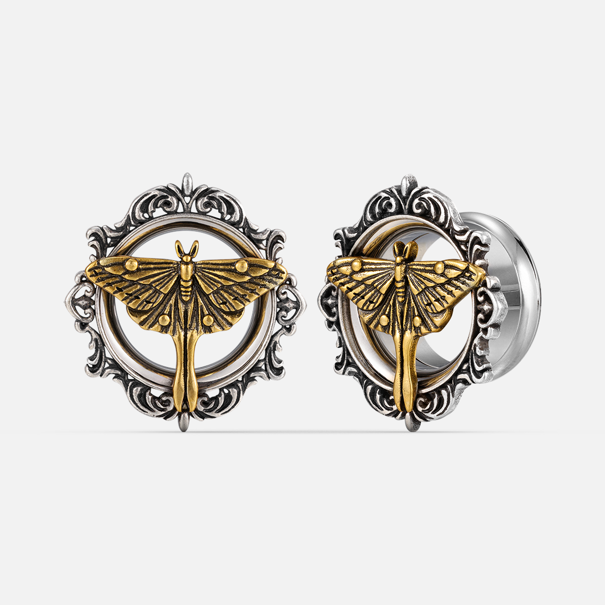 Pair of ornate silver-tone ear tunnels with gold-tone moth motif and scrolled filigree frame, front and side view