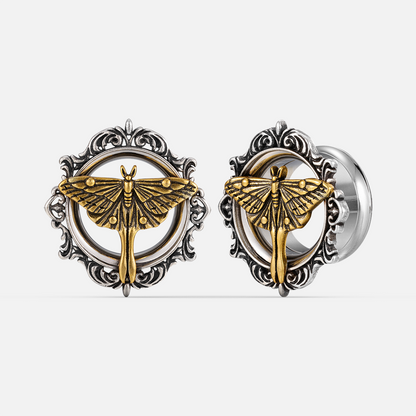 Pair of ornate silver-tone ear tunnels with gold-tone moth motif and scrolled filigree frame, front and side view