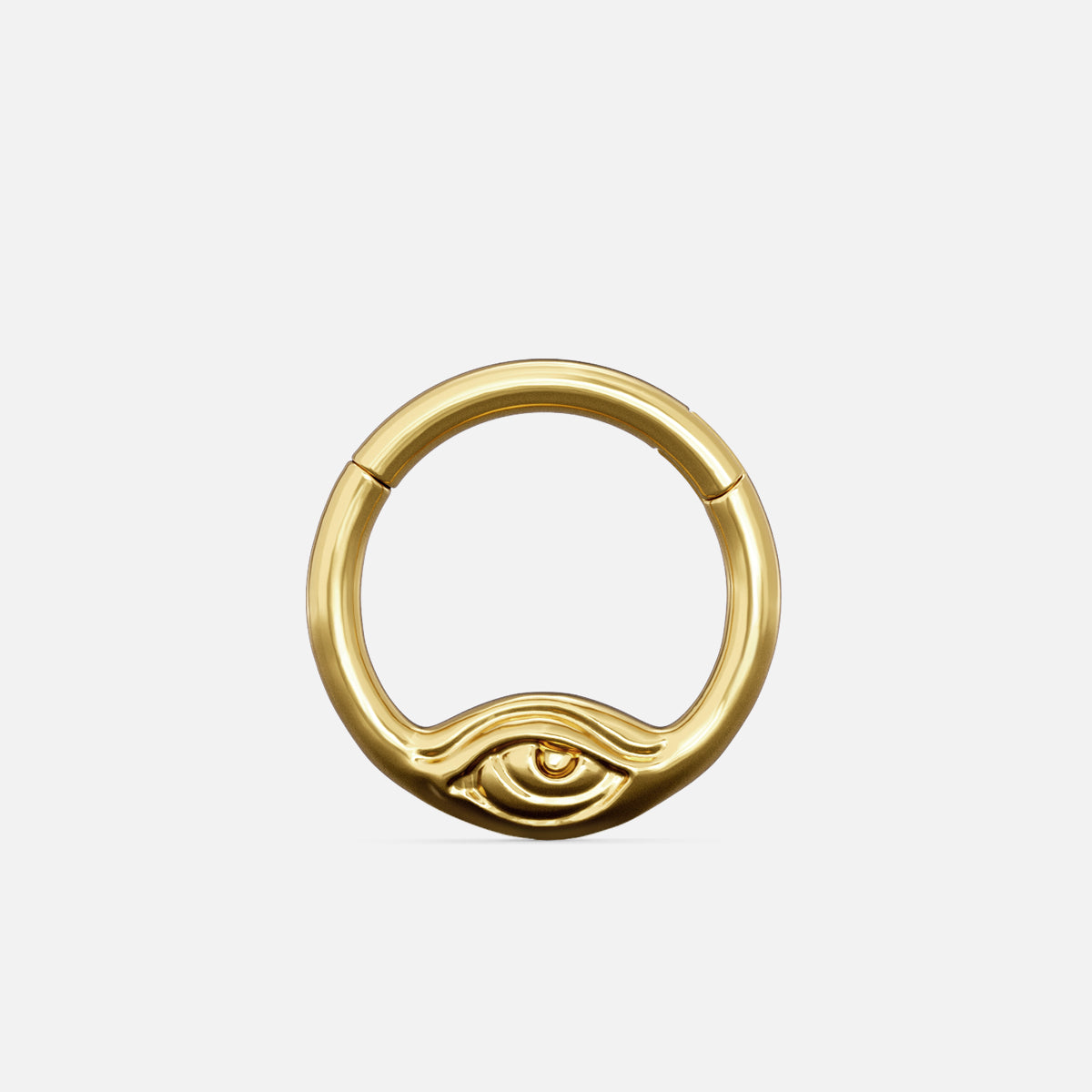 Gold-tone Eyelock Clicker with a rounded ring and a sculpted eye detail along the lower edge.