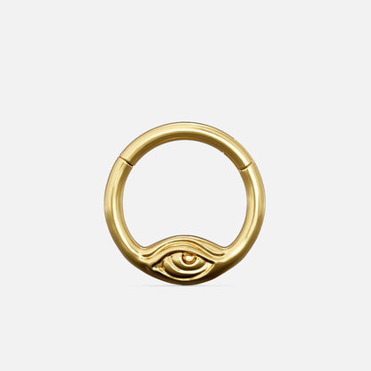 Gold-tone Eyelock Clicker with a rounded ring and a sculpted eye detail along the lower edge.