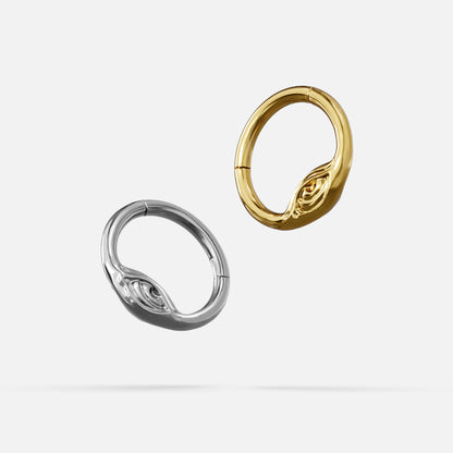 Silver- and gold-tone Eyelock Clickers displayed together from angled views on a light gray background.