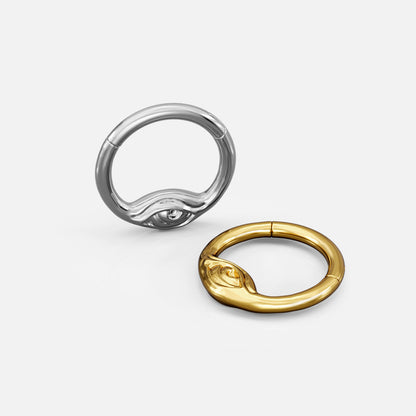 Silver- and gold-tone Eyelock Clickers shown from multiple angles to display the ring profile and eye detail.