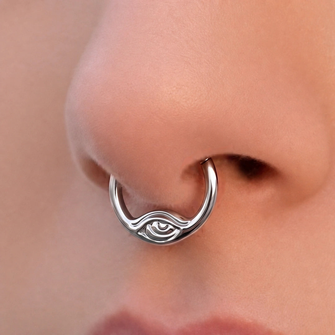 Silver-tone Eyelock Clicker worn as a septum ring, featuring a subtle eye-shaped detail.