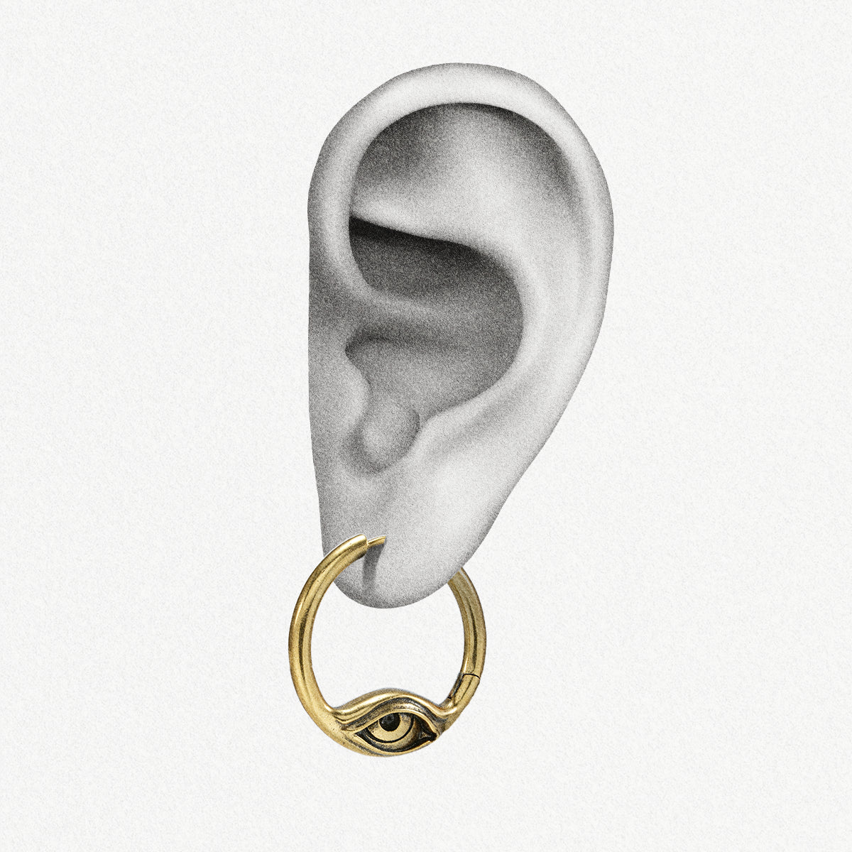 Gold-tone Eyelock hoop earring positioned on an illustrated earlobe with the sculpted eye facing forward