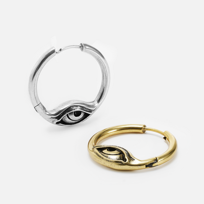 Silver and gold-tone Eyelock hoop earrings displayed together with sculpted eye details along the lower curve