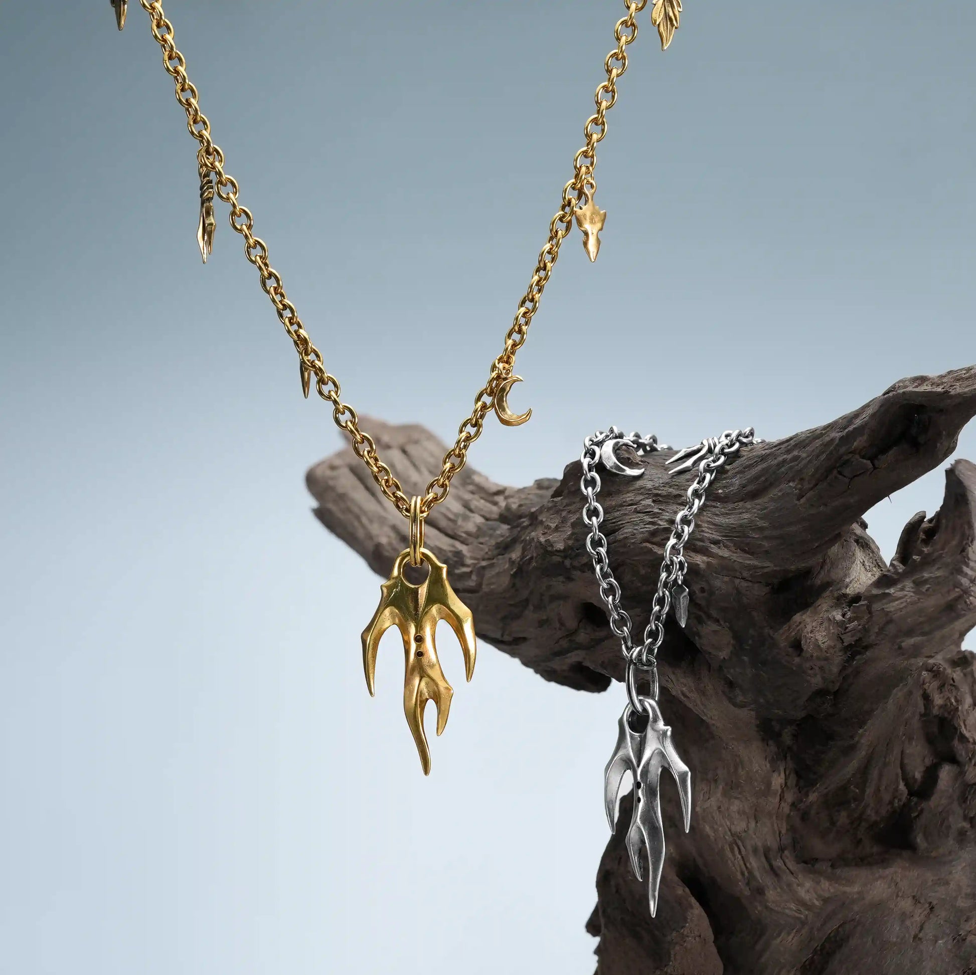 Silver & Gold Feral Husk Necklace photographed on driftwood for witchwood jewelry styling