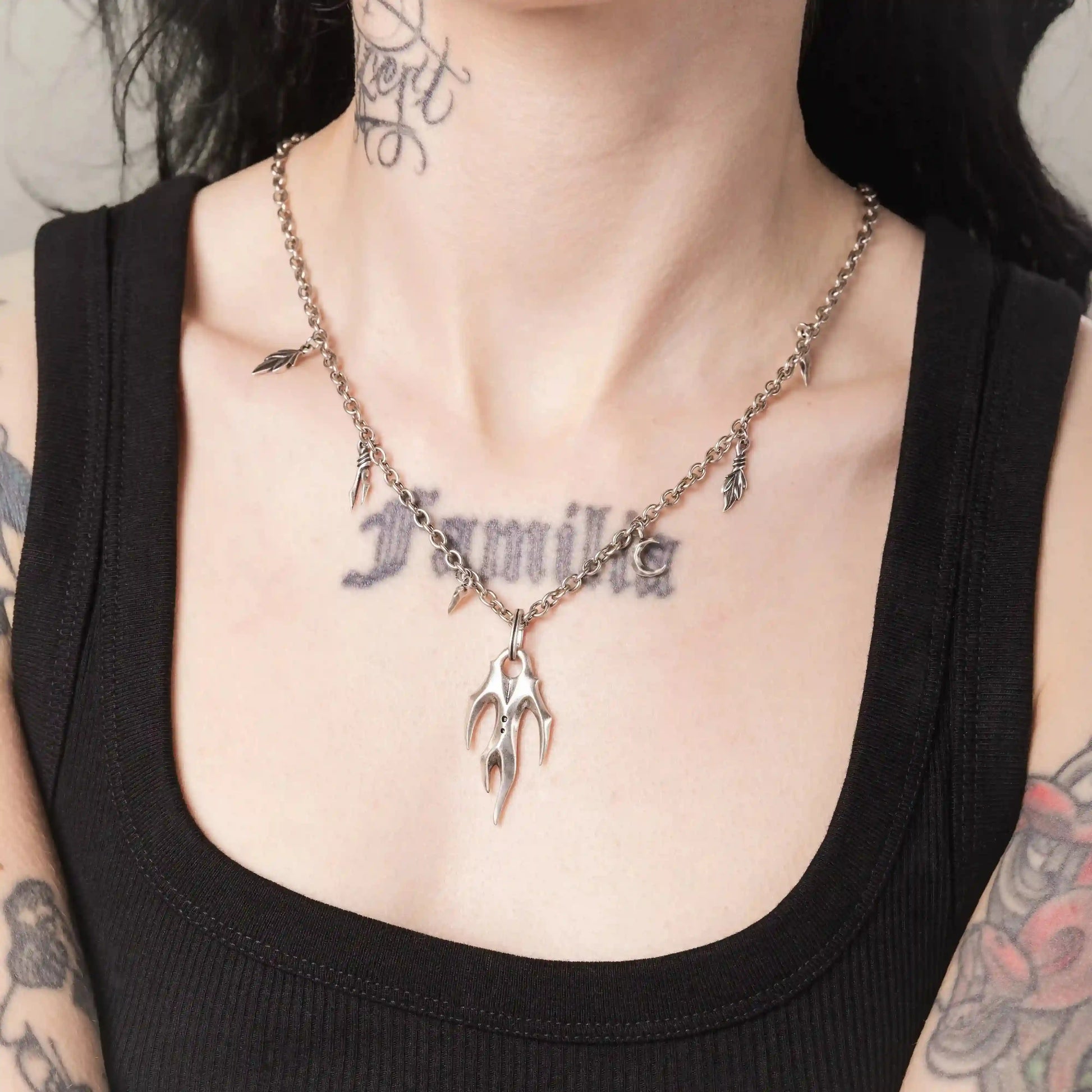 Model wearing the silver Feral Husk Necklace with wild claw pendant and leaf charms