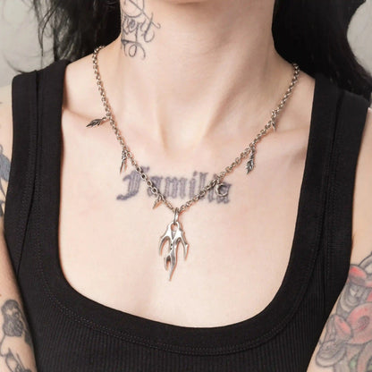 Model wearing the silver Feral Husk Necklace with wild claw pendant and leaf charms