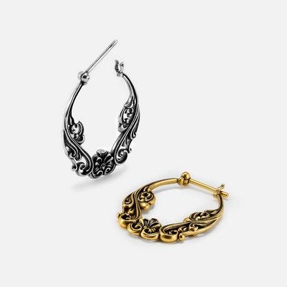 Silver-tone and gold-tone floral scroll hoop earrings displayed side by side at an angle