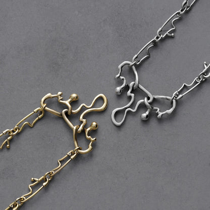 Silver and gold Fluid Pin necklaces with abstract melting chain links