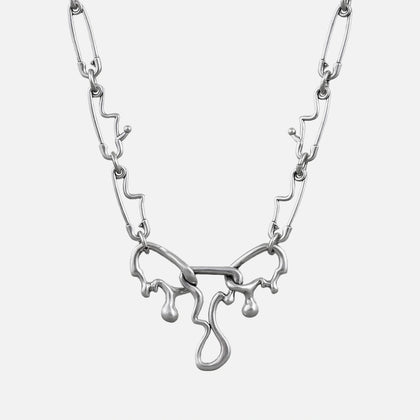 Silver-tone fluid pin necklace with a wavy paperclip chain and dripping abstract pendant, front view