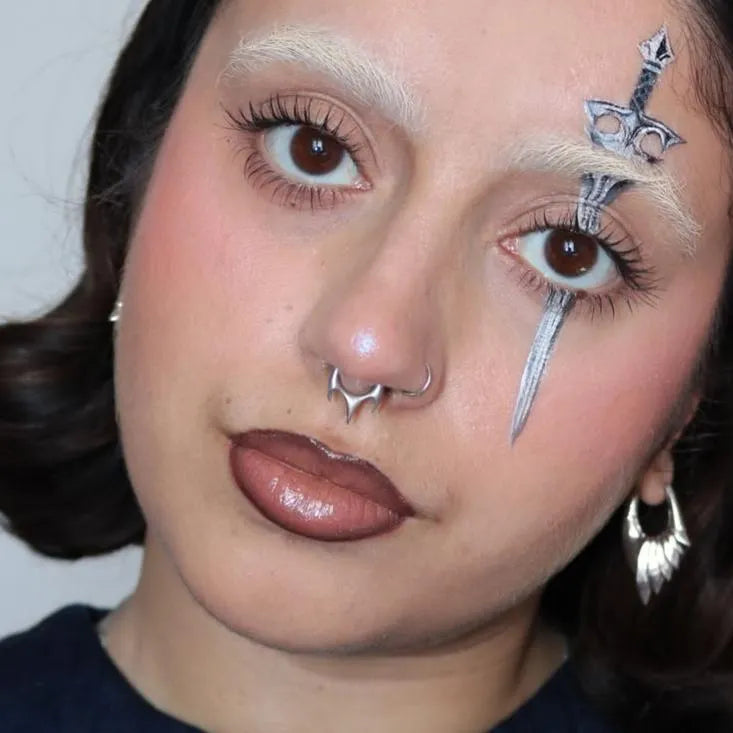 Silver Focused Fang Clicker styled on model with central fang point and minimalist gothic septum jewelry look